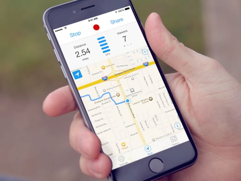 Person checking live train status on a mobile app at the station