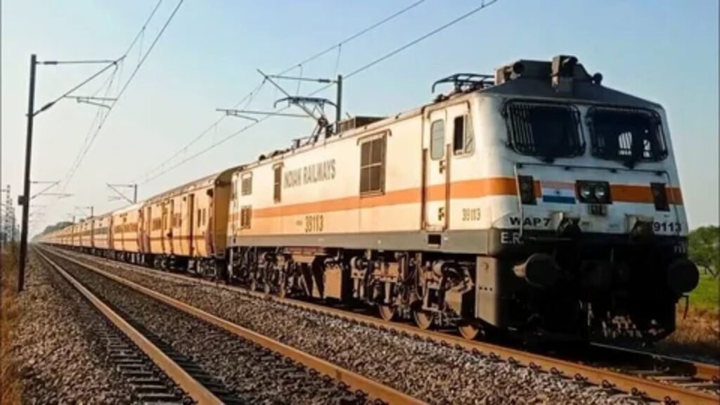 Modern passenger train traveling on railway tracks during daytime.