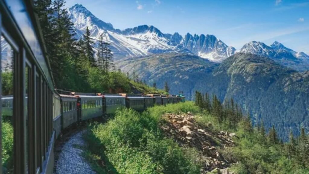 Amtrak train traveling through scenic mountain landscapes in the USA.