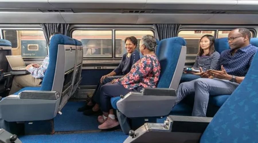 Spacious Amtrak Coach Class interior showing comfortable reclining passenger seats and legroom