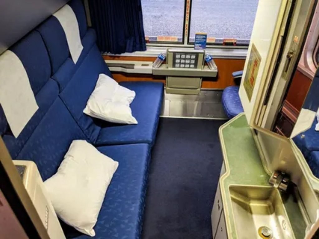 Amtrak Roomette private sleeping accommodation setup inside a long distance sleeper car