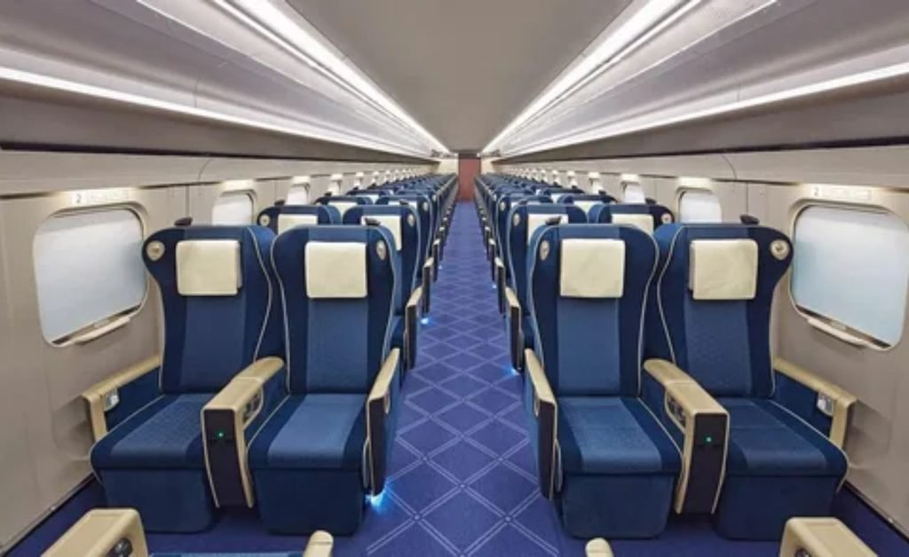 Passenger relaxing in a comfortable Amtrak train seat with laptop and window view