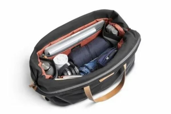 Train travel packing essentials including headphones snacks camera and travel bag