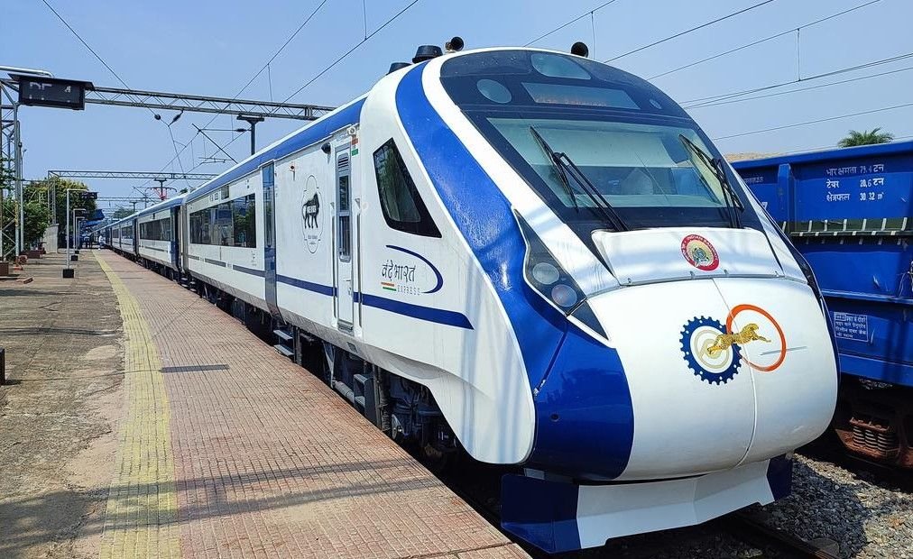 person using app trani train travel app on mobile phone at railway station