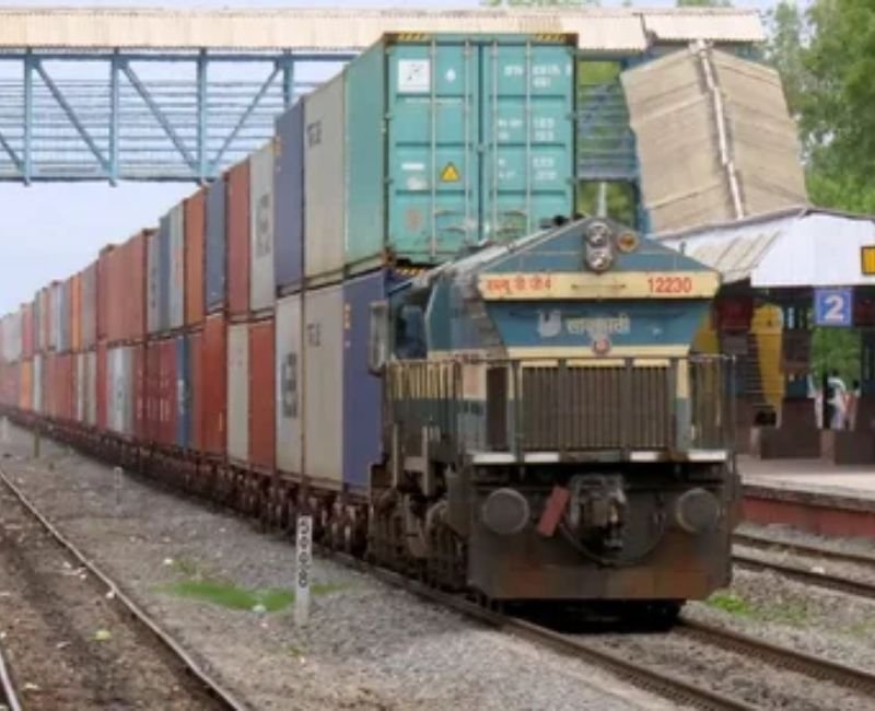 Long freight train carrying heavy cargo and industrial goods.