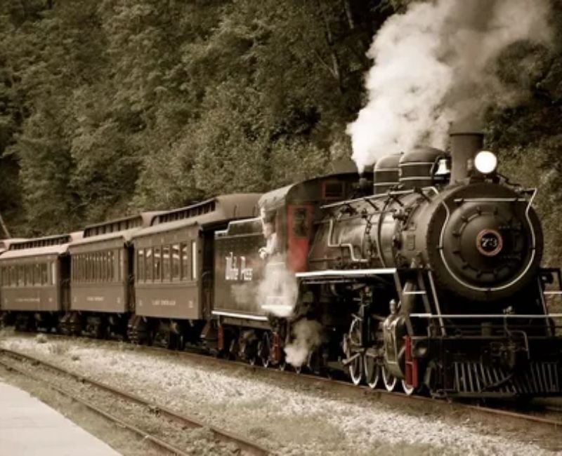 Historical steam train engine representing early railway transportation history.