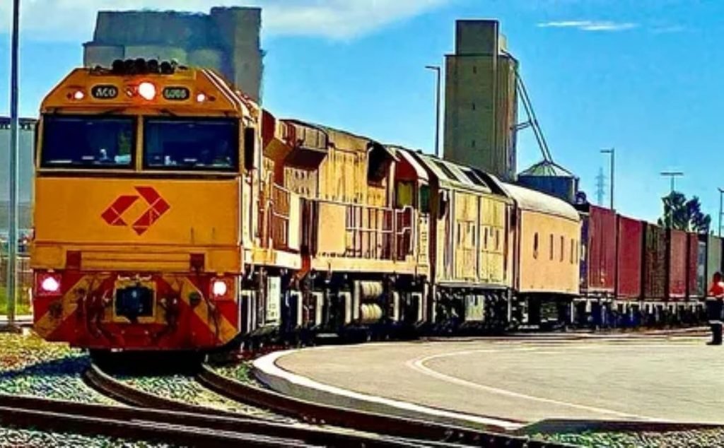 Cargo freight train carrying goods on long distance railway tracks.