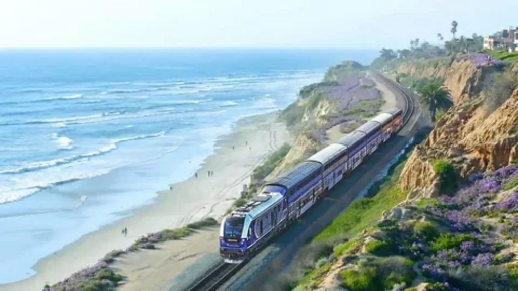 Amtrak passenger train traveling through scenic American countryside.