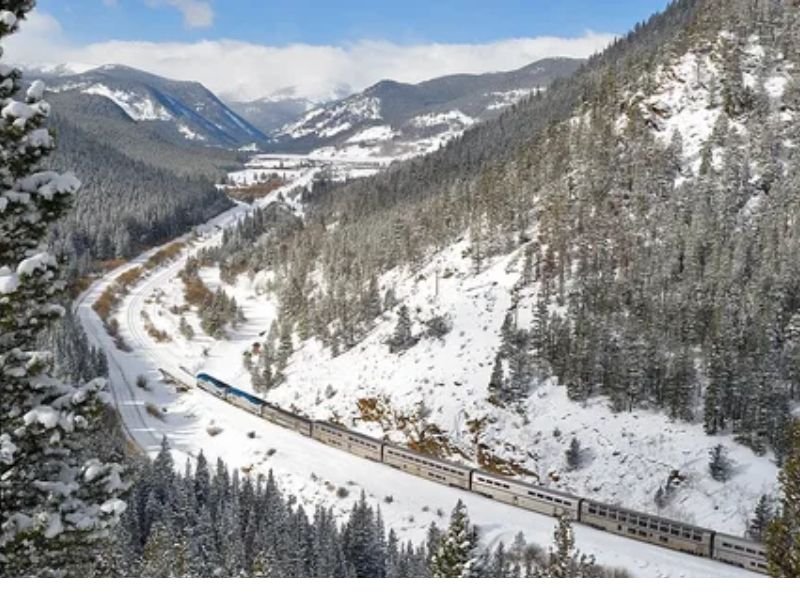 Amtrak California Zephyr train passing through the scenic Rocky Mountains.