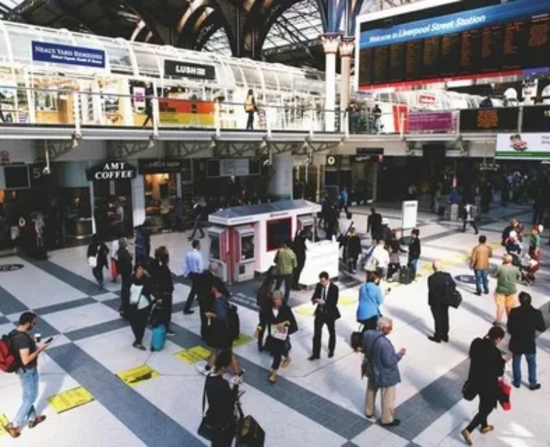 Train station terminal with digital information board and platforms.