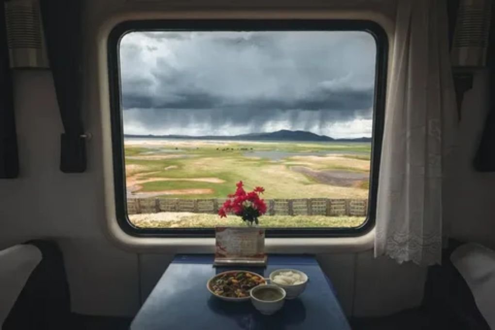 Passenger looking out the window of a scenic train ride