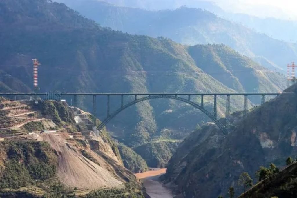 Passenger train crossing a bridge with a beautiful coastal landscape view