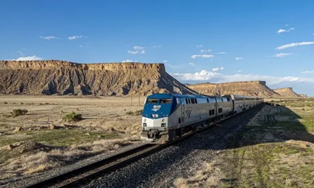 Scenic Amtrak long-distance train traveling through a picturesque coastal landscape