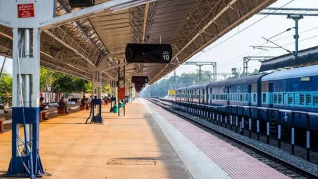Passengers waiting at a modern railway station platform for arrival of transport train.