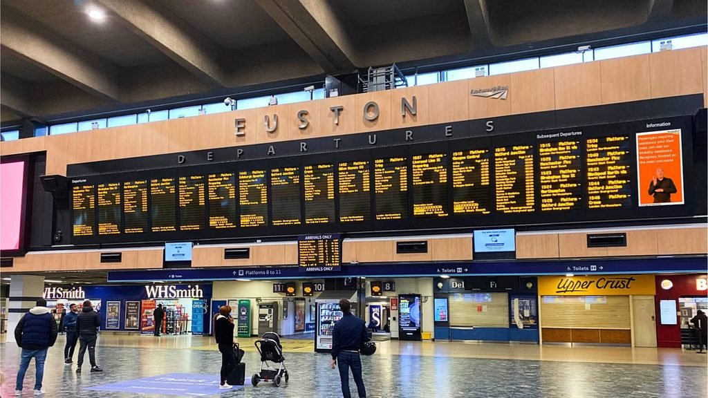 London Euston station concourse with departure boards for Birmingham trains