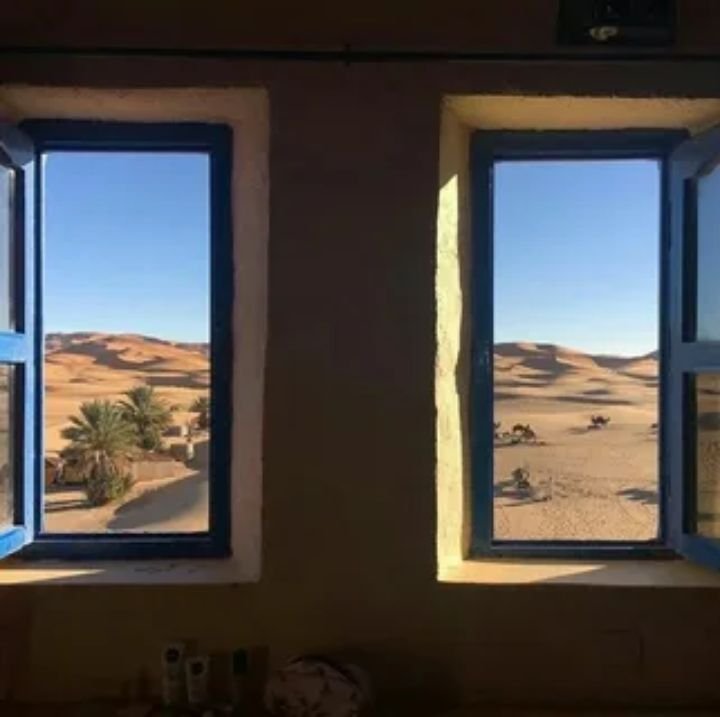 Scenic mountain and valley views seen through an Amtrak observation car window