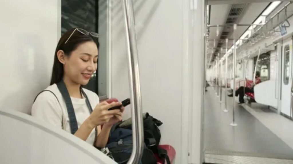 Passenger using a camera to capture scenic landscape views from an Amtrak train lounge