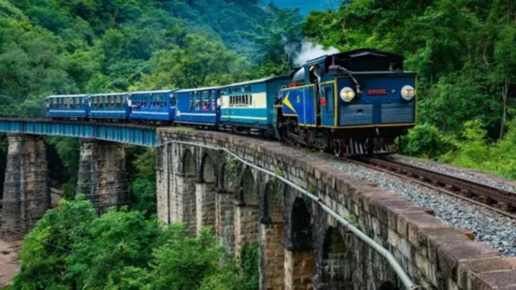 Scenic passenger train traveling through majestic mountain landscape and lush valley