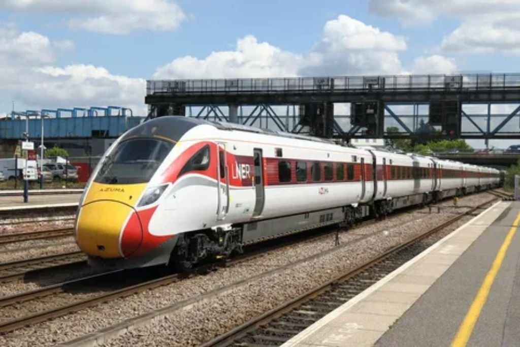 Modern train traveling through scenic British countryside from London to Scotland