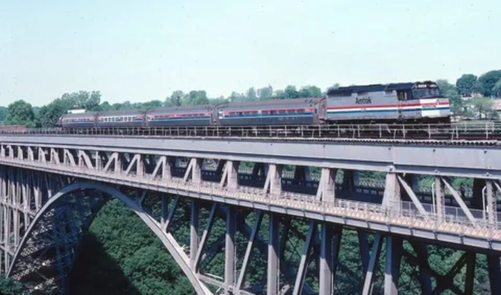 Amtrak Maple Leaf train traveling through scenic countryside on New York to Toronto route