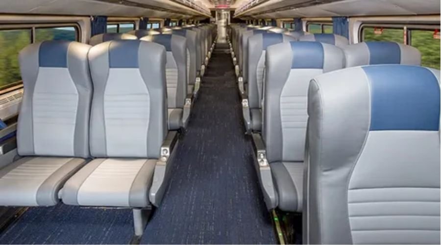 Comfortable interior seating and window view inside the New York to Toronto train