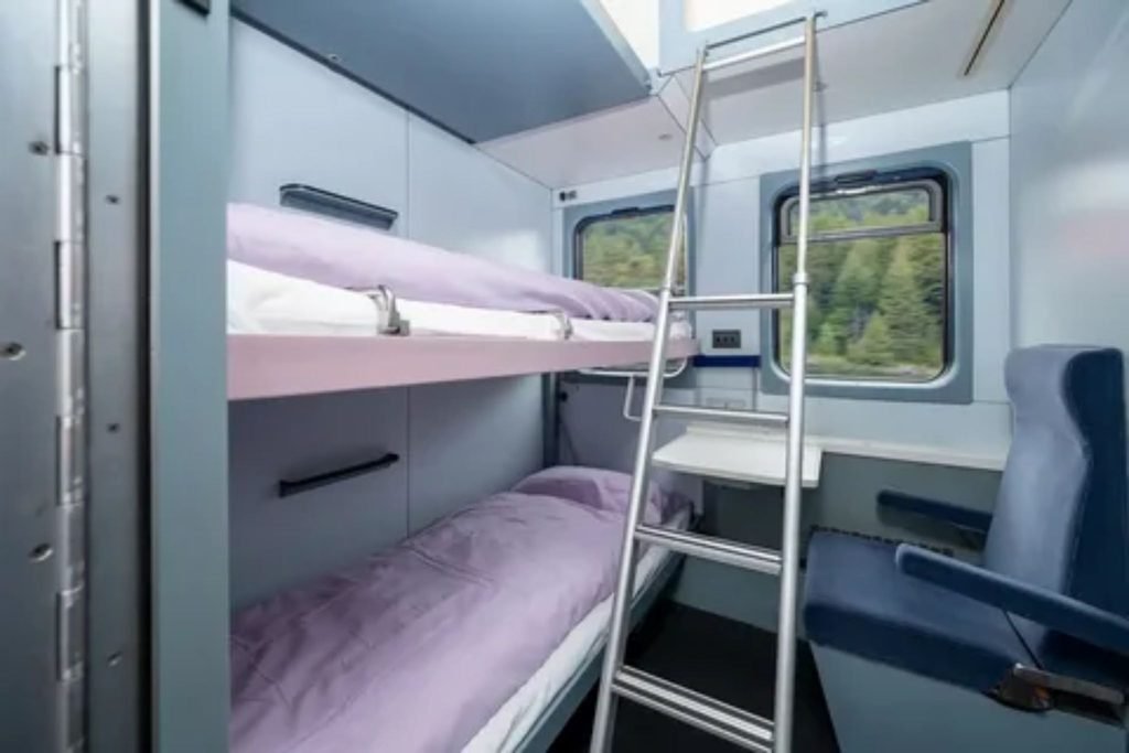 Comfortable passenger seats and window view inside a long-distance passenger train