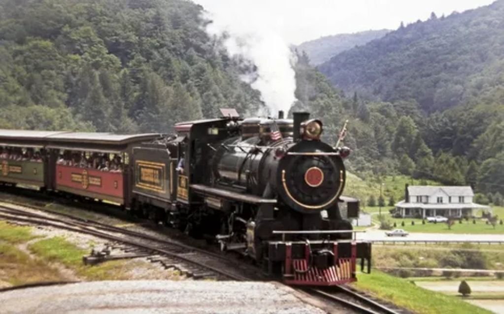 Historic Great Smoky Mountains Railroad steam engine operating a scenic winter holiday train trip in North Carolina.