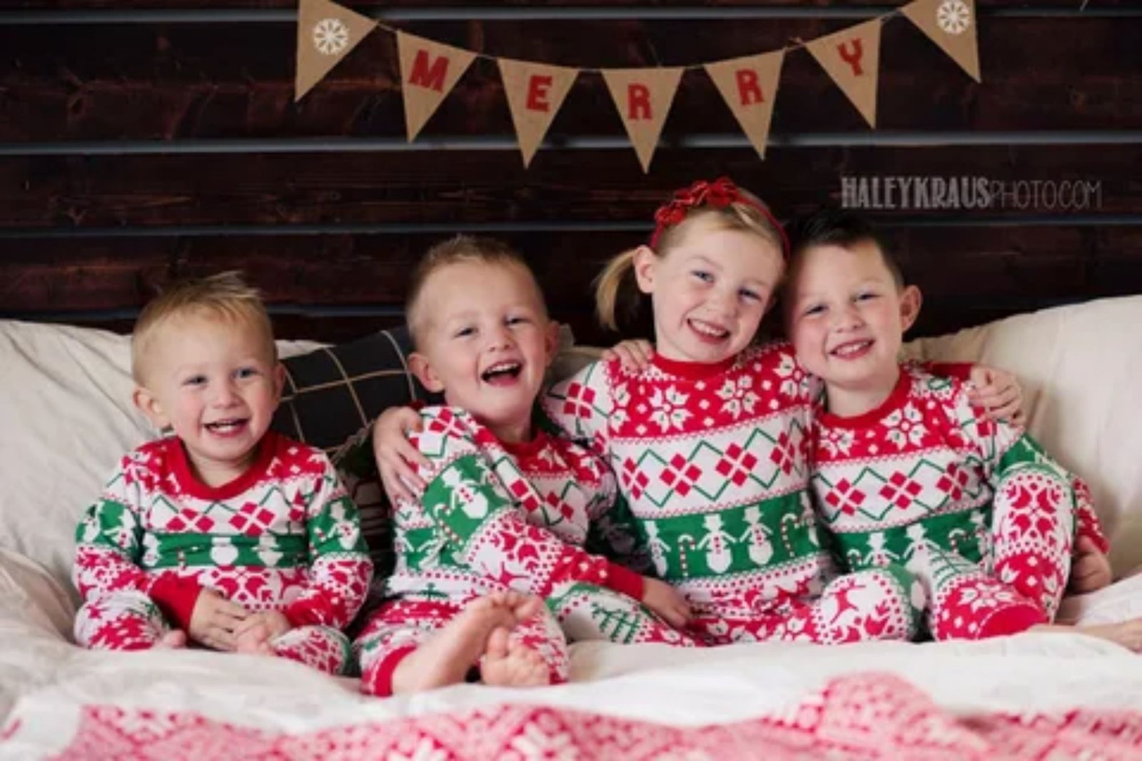 Family wearing cozy Christmas pajamas enjoying hot chocolate inside a decorated holiday train car in North Carolina.