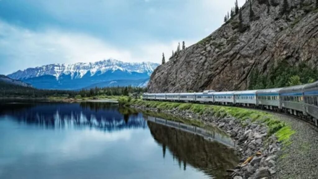 VIA Rail train traveling through scenic Canadian mountain landscape from Toronto to Vancouver