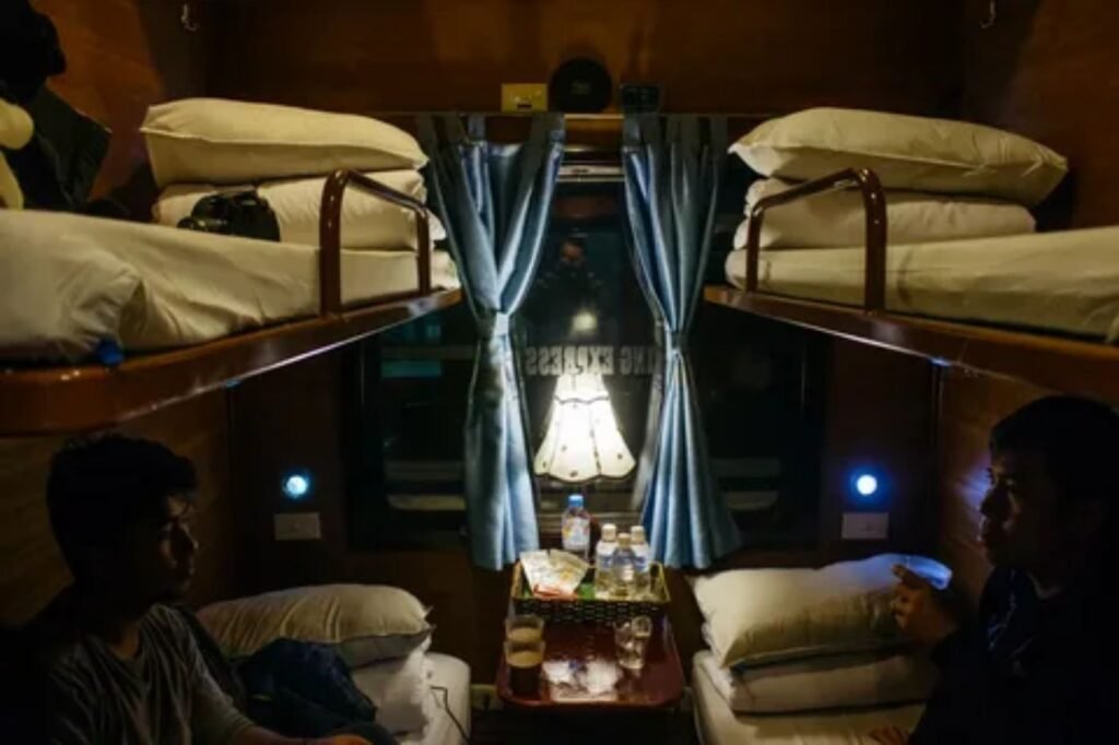 Passenger relaxing safely in an overnight train sleeper compartment with secure belongings
