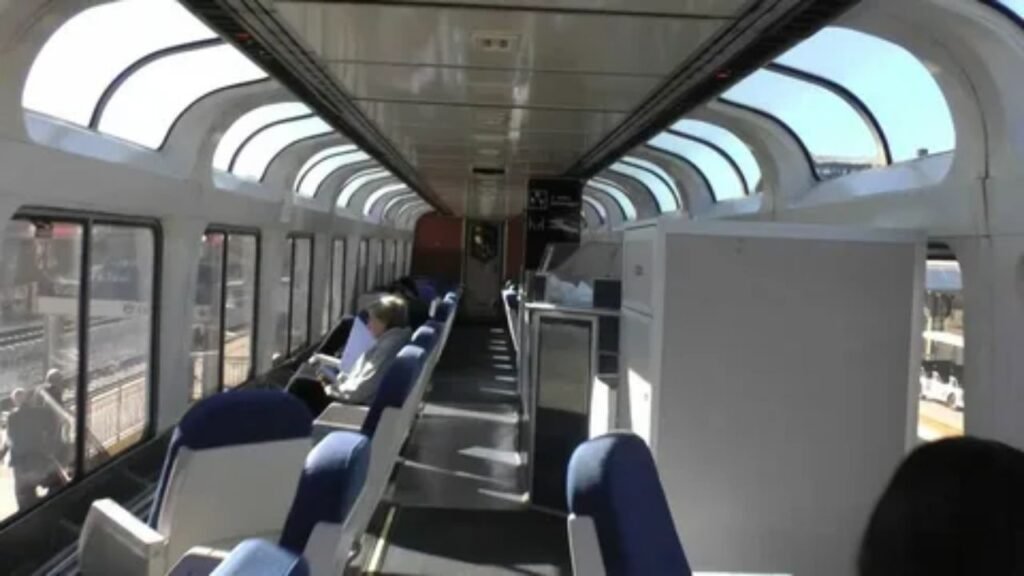 Passengers enjoying scenic views from the observation car on an American train journey