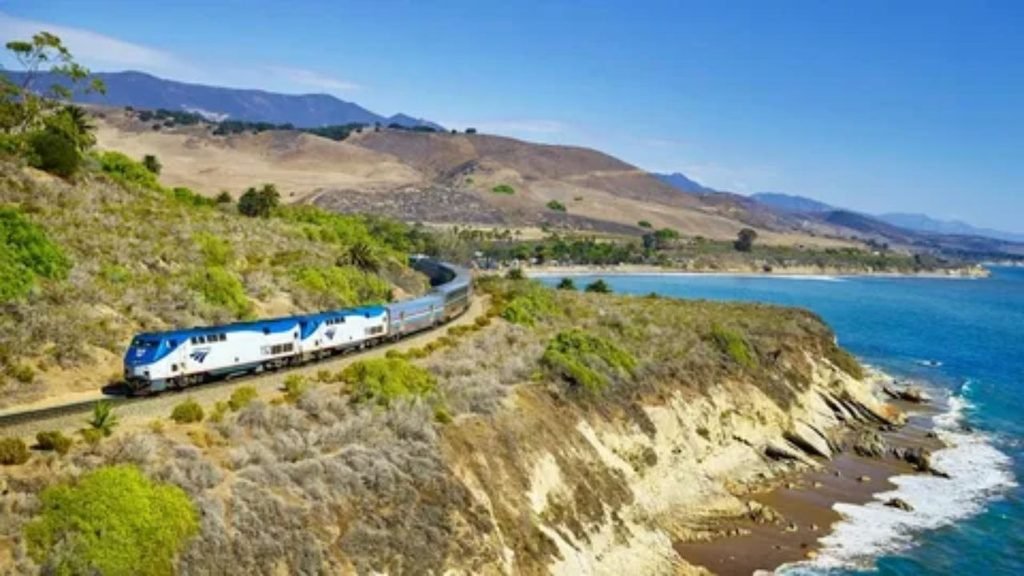 Train traveling along the Pacific coastline with ocean views in the United States