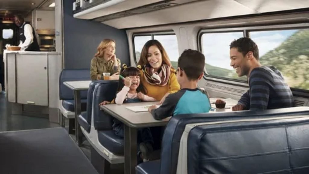 Happy family enjoying scenic views together inside an Amtrak lounge car