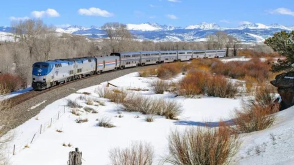Passenger train passing through the scenic Rocky Mountains in Colorado