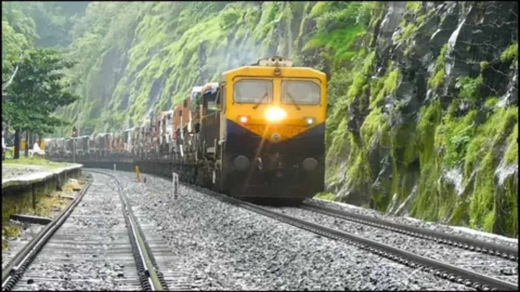 Comparison of train traveling through open countryside alongside a highway out West